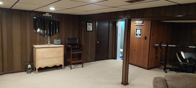 interior space with wooden walls, recessed lighting, visible vents, and light carpet