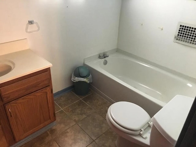 full bathroom with baseboards, toilet, a bath, tile patterned floors, and vanity