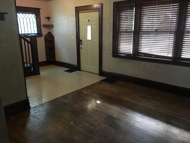 entrance foyer with wood finished floors, stairs, and baseboards