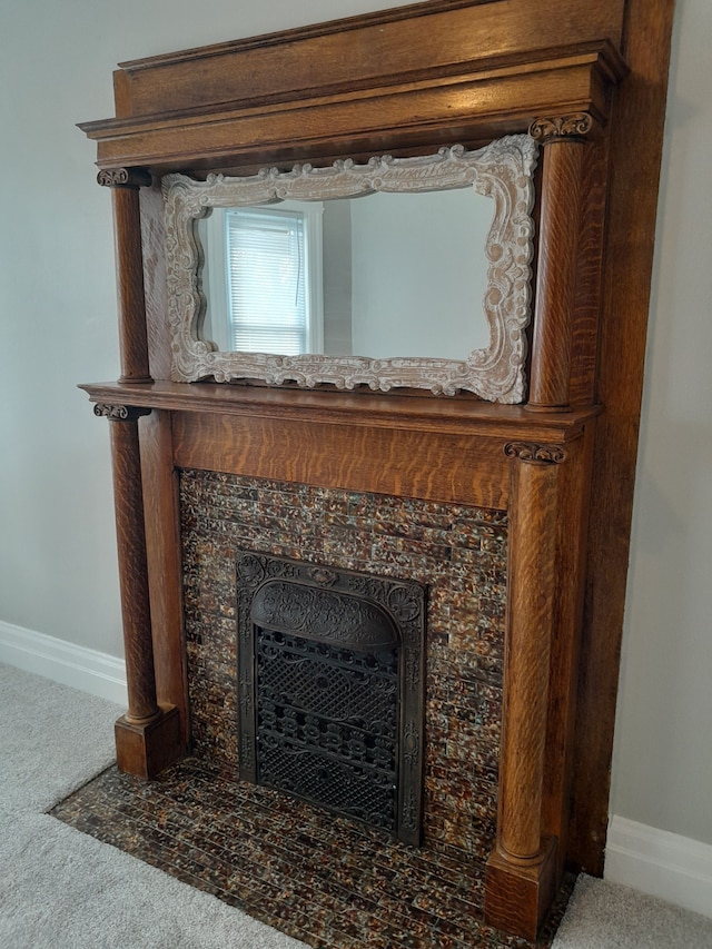 interior details with carpet floors, a premium fireplace, and baseboards