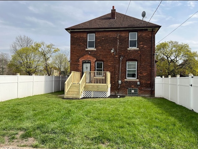 728 W Philadelphia St, Detroit, MI 48202 - rear view of house featuring roof with shingles, brick siding, and a chimney