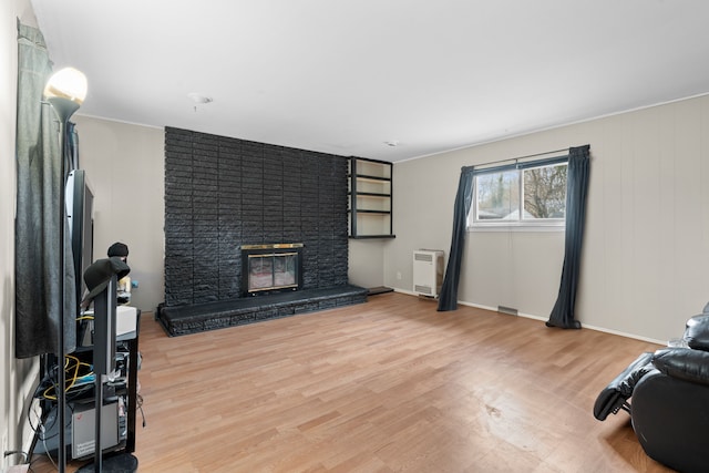 11394 Centralia, Redford, MI 48239 - living room with a brick fireplace, heating unit, and light wood-style flooring