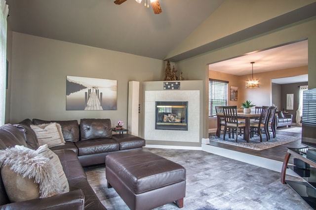 8313 Mill Pointe Ct, Goodrich, MI 48438 - living area with a chandelier, wood finished floors, vaulted ceiling, ceiling fan, and a fireplace
