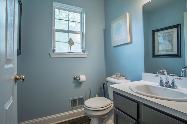 8313 Mill Pointe Ct, Goodrich, MI 48438 - half bath featuring toilet, vanity, and wood finished floors