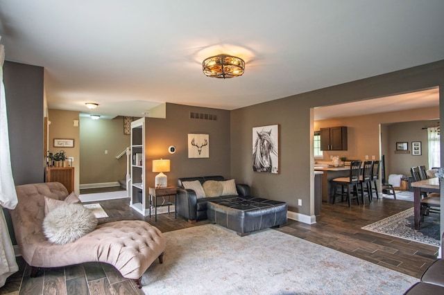 8313 Mill Pointe Ct, Goodrich, MI 48438 - living room featuring dark wood-style flooring, stairs, baseboards, and plenty of natural light