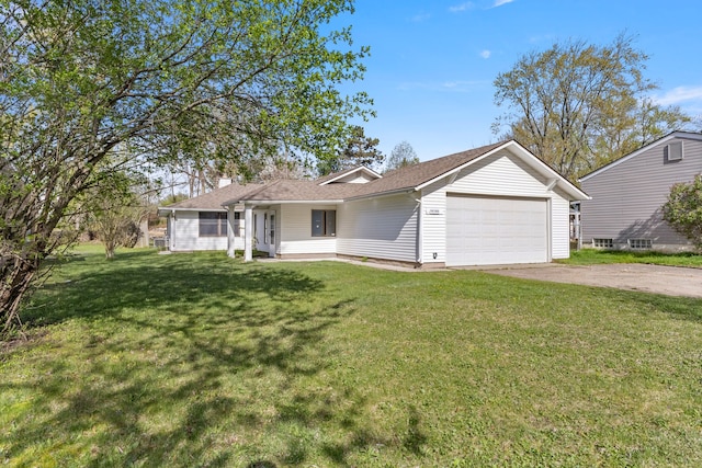 ranch-style house featuring a garage, a front lawn, and driveway