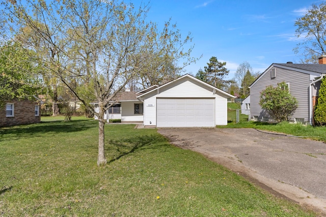 ranch-style house with a garage, aphalt driveway, and a front lawn