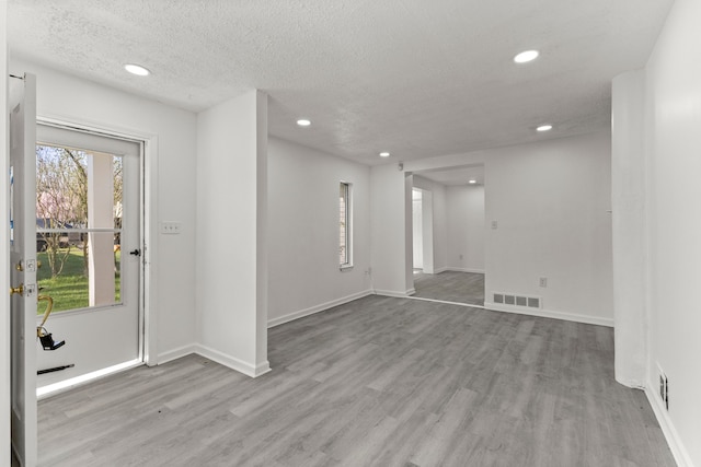 foyer with recessed lighting, visible vents, and wood finished floors