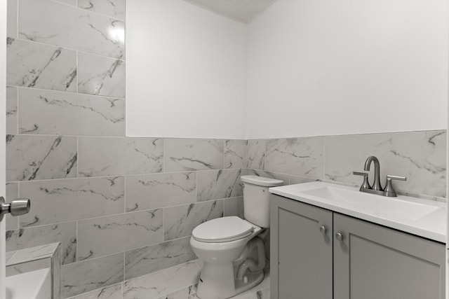 bathroom featuring toilet and vanity