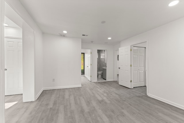 spare room featuring baseboards, recessed lighting, visible vents, and light wood finished floors