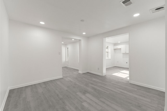 empty room featuring visible vents, recessed lighting, and light wood finished floors