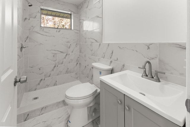 full bath featuring vanity, toilet, a stall shower, and tile walls
