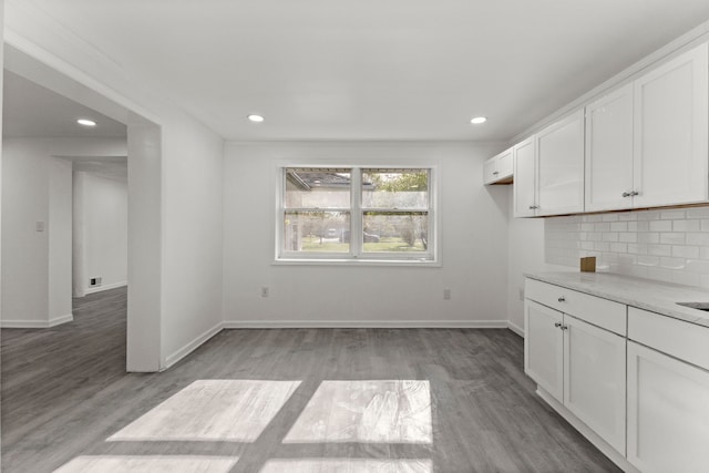interior space with baseboards, recessed lighting, and light wood-style floors