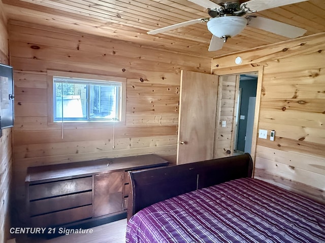 bedroom featuring wooden walls and wood ceiling