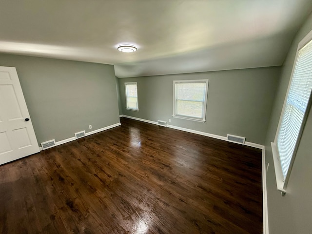 empty room featuring dark wood finished floors and visible vents