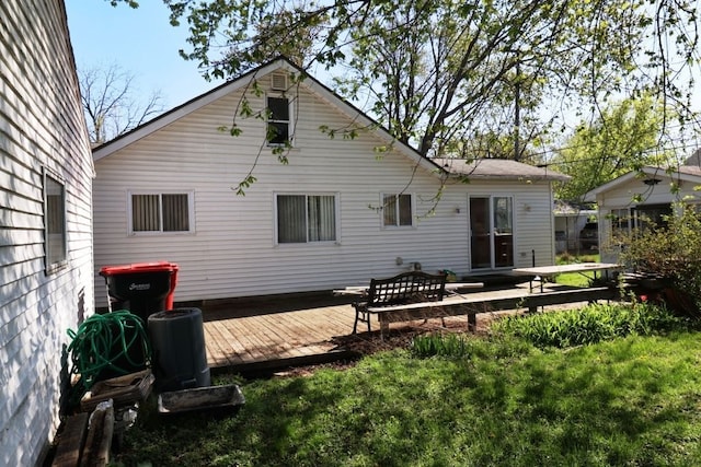 back of house featuring a deck