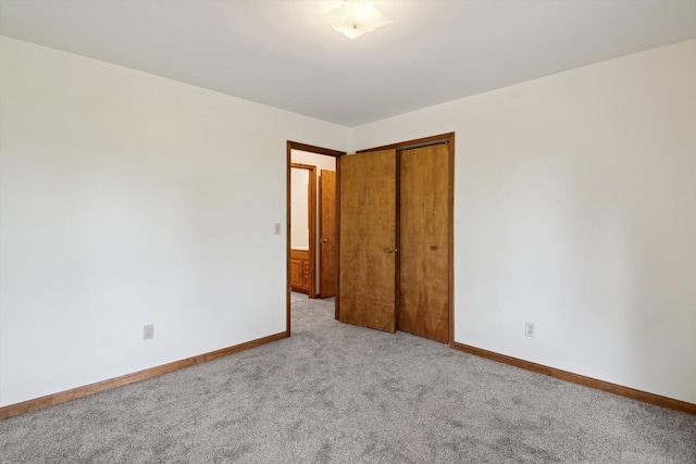 7996 Cain Rd, Jackson, MI 49201 - unfurnished bedroom featuring a closet, light carpet, and baseboards
