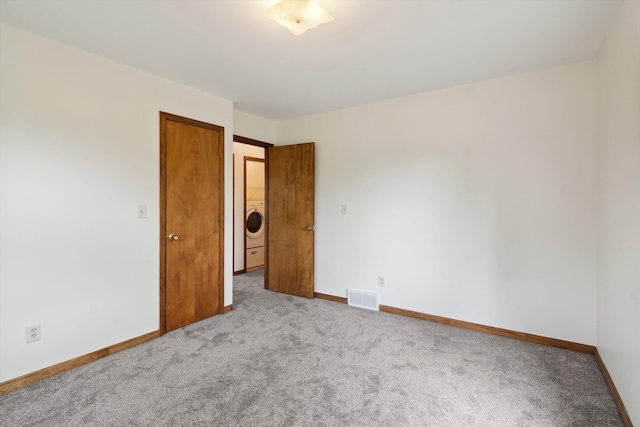 7996 Cain Rd, Jackson, MI 49201 - carpeted spare room featuring visible vents, baseboards, and washer / clothes dryer