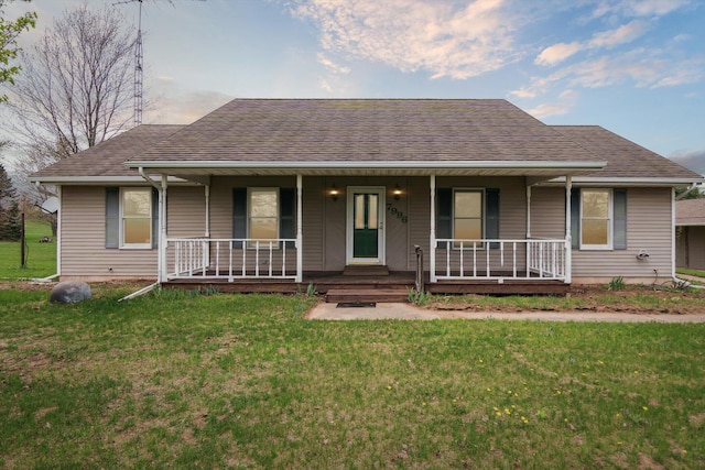 7996 Cain Rd, Jackson, MI 49201 - view of front facade with roof with shingles, a porch, and a front lawn