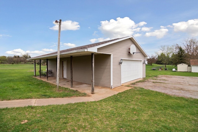 7996 Cain Rd, Jackson, MI 49201 - view of home's exterior featuring driveway, a garage, a lawn, and an outbuilding