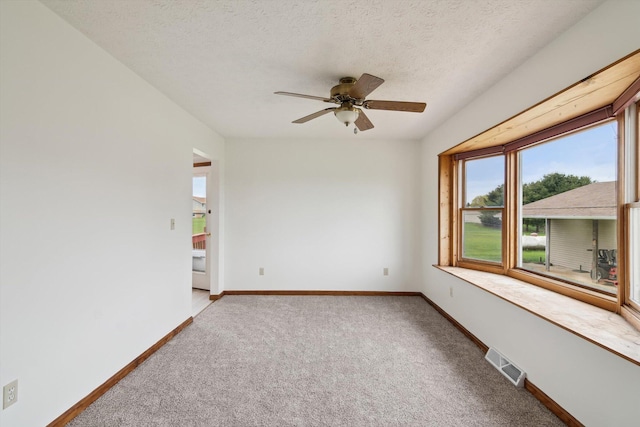 7996 Cain Rd, Jackson, MI 49201 - unfurnished room with carpet floors, ceiling fan, baseboards, visible vents, and a textured ceiling