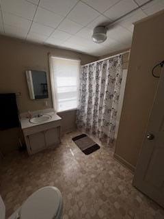 600 Benson Rd, Benton Harbor, MI 49022 - full bath featuring a shower with shower curtain, toilet, tile patterned floors, vanity, and a paneled ceiling
