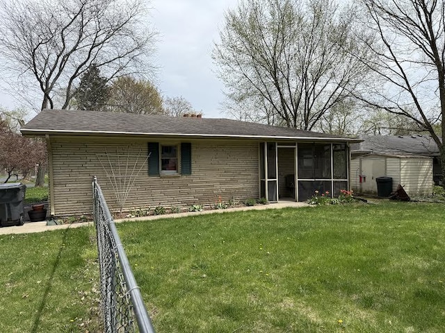 5346 E H Ave, Kalamazoo, MI 49048 - back of property with a storage shed, a sunroom, a lawn, and fence
