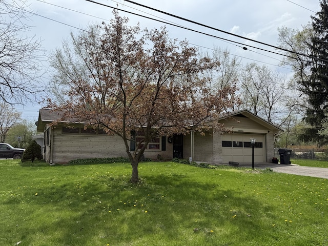5346 E H Ave, Kalamazoo, MI 49048 - view of front facade featuring a garage, brick siding, aphalt driveway, and a front lawn