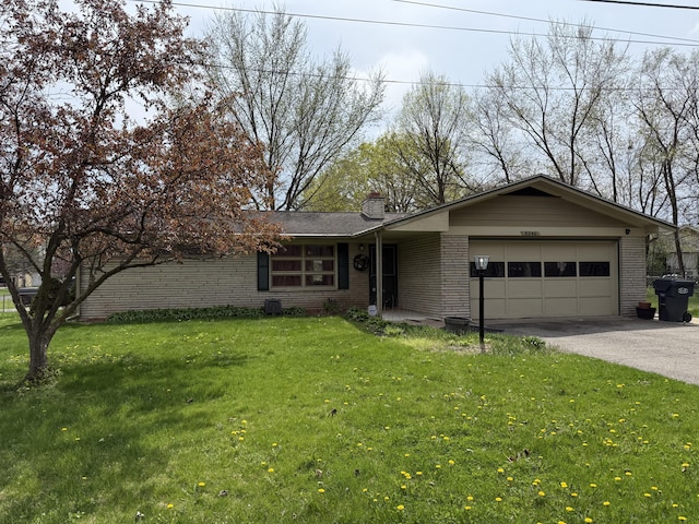 5346 E H Ave, Kalamazoo, MI 49048 - ranch-style home featuring a front yard, brick siding, driveway, a chimney, and an attached garage
