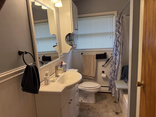 5346 E H Ave, Kalamazoo, MI 49048 - full bathroom featuring vanity, curtained shower, toilet, wainscoting, and a baseboard radiator