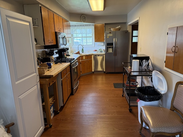5346 E H Ave, Kalamazoo, MI 49048 - kitchen with a sink, brown cabinets, appliances with stainless steel finishes, and dark wood finished floors