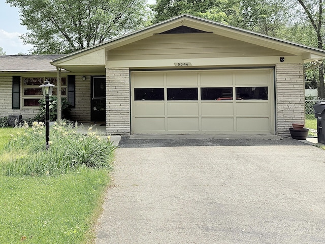 5346 E H Ave, Kalamazoo, MI 49048 - ranch-style home with brick siding, asphalt driveway, and an attached garage