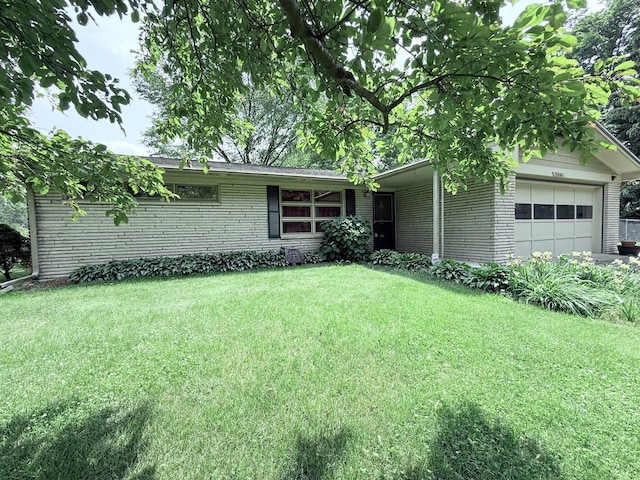 5346 E H Ave, Kalamazoo, MI 49048 - view of front of house with an attached garage, brick siding, and a front lawn
