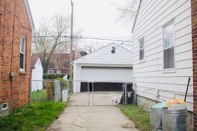 detached garage featuring a gate and fence