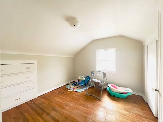 bonus room with baseboards, lofted ceiling, and wood finished floors