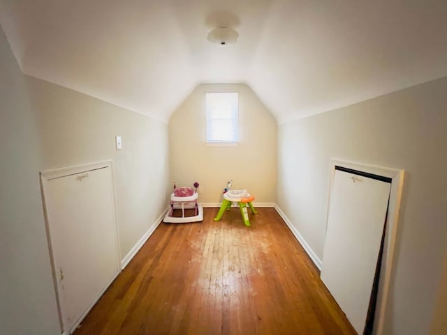 game room with baseboards, vaulted ceiling, and hardwood / wood-style flooring
