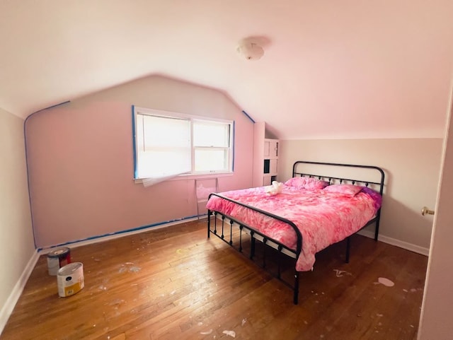 bedroom with wood-type flooring, baseboards, and lofted ceiling