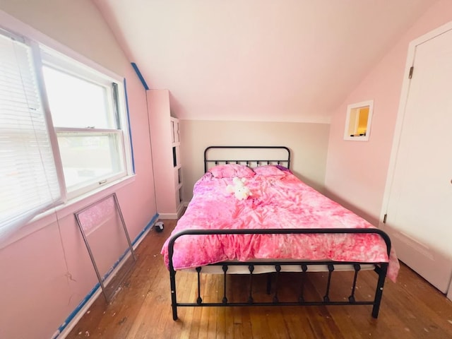 bedroom featuring vaulted ceiling and hardwood / wood-style flooring