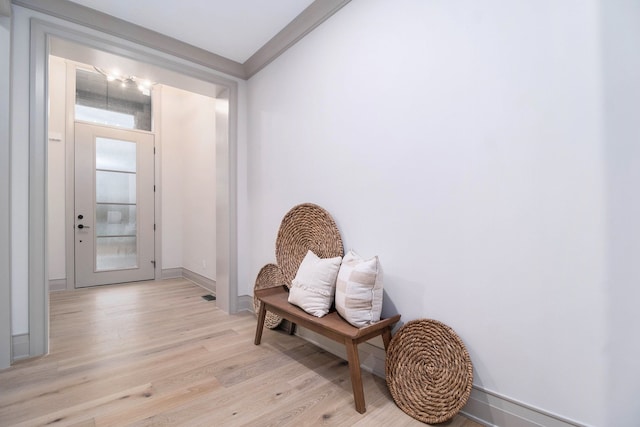 doorway featuring baseboards and light wood-style flooring