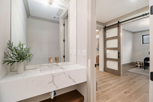 bathroom with crown molding, wood finished floors, and visible vents