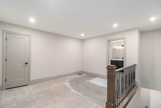 interior space with baseboards and recessed lighting