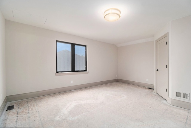 unfurnished room with visible vents and baseboards