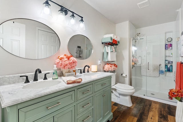 12031 E Schonborn Pl N Unit 3, Clio, MI 48420 - bathroom featuring visible vents, a sink, a stall shower, and toilet