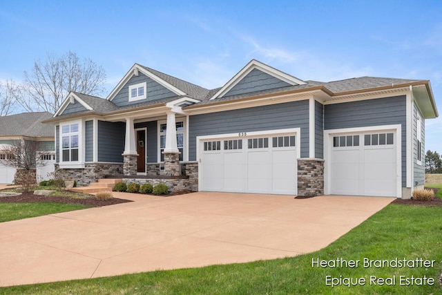 craftsman inspired home featuring stone siding, concrete driveway, a porch, and a garage