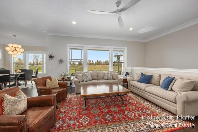 living room featuring crown molding, recessed lighting, wood finished floors, and ceiling fan with notable chandelier