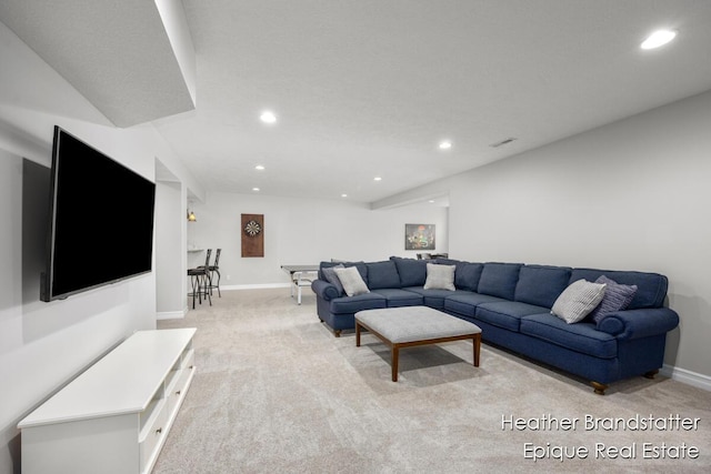living room with baseboards, recessed lighting, visible vents, and light carpet