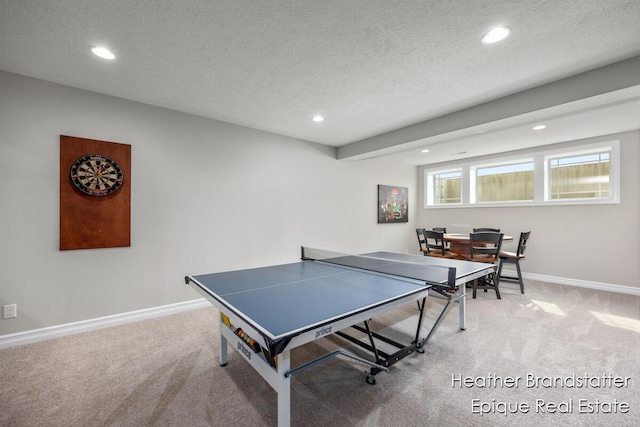 recreation room featuring recessed lighting, a textured ceiling, light carpet, and baseboards