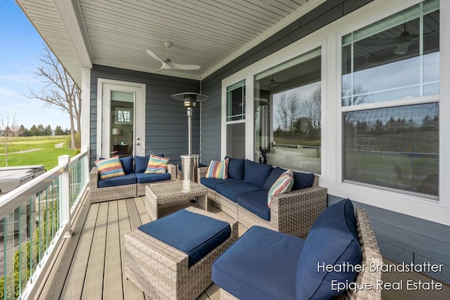 deck with outdoor lounge area and ceiling fan