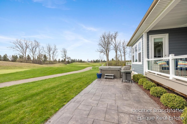view of patio / terrace with a grill and a hot tub