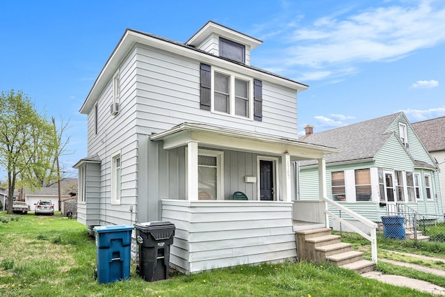 traditional style home with a front yard and covered porch